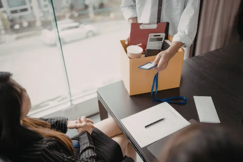 Employee and employment attorney discussing settlement options after wrongful termination in California.